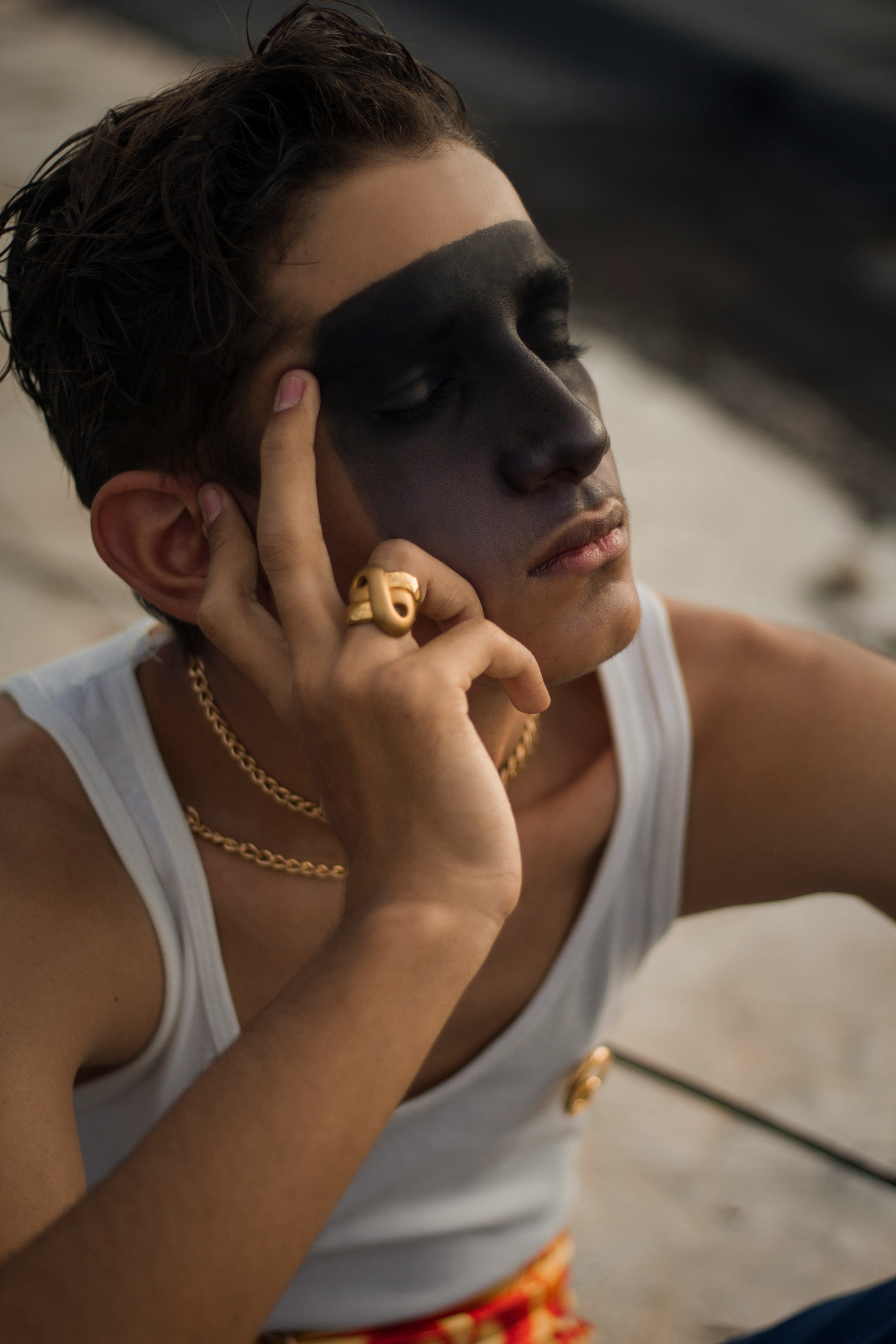 man in white tank top wearing gold watch